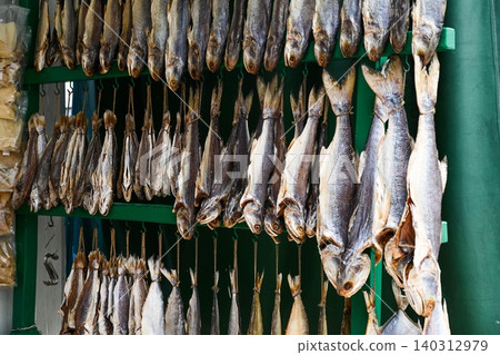 Close up abstract view of traditional Chinese salted dried fish hanging on hooks at outdoor seafood street market in Macau Close up abstract view of traditional Chinese salted dried fish hanging on hooks at outdoor seafood street market in Macau 140312979