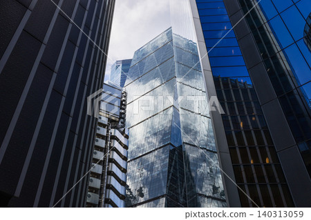 Glass skyscrapers reflecting blue sky and clouds in city 140313059