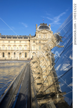 Paris, France - July 04, 2018: Reflection of the Louvre building in the glass pyramid of the Louvre Museum Paris, France - July 04, 2018: Reflection of the Louvre building in the glass pyramid of the Louvre Museum 140313222