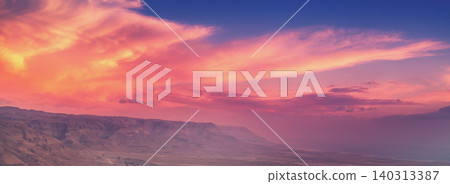 Mountain desert landscape. View of the valley from the mount. Desert in the early morning. Beautiful sunrise over Masada with dramatic sky. The Judaean Desert. Landscape in Dead sea region. Nature Mountain desert landscape. View of the valley from the mount. Desert in the early morning. Beautiful sunrise over Masada with dramatic sky. The Judaean Desert. Landscape in Dead sea region. Nature 140313387