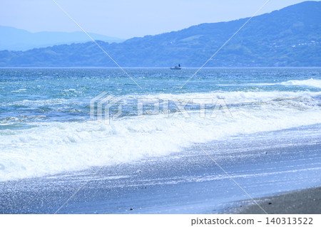 A view of the waves at the water's edge on the beach A view of the waves at the water's edge on the beach 140313522