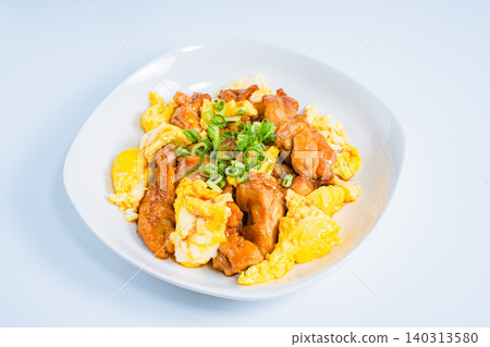 A photo of a Japanese-style dish of teriyaki chicken and egg stir-fried in a sweet and savory sauce. A photo of a Japanese-style dish of teriyaki chicken and egg stir-fried in a sweet and savory sauce. 140313580