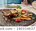 Close up view of delicious roast chicken steak with sauce, served with mashed potatoes and side vegetables on a black plate in a restaurant. 140314637