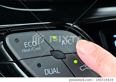 A woman's fingers turn on the air conditioner switch A woman's fingers turn on the air conditioner switch 140314819