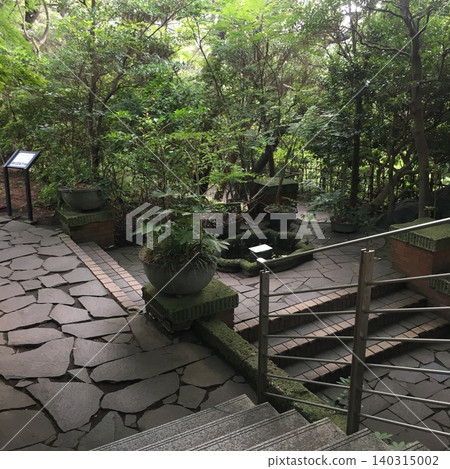 The cobblestone steps and small garden of the museum The cobblestone steps and small garden of the museum 140315002