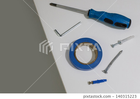 Several tools are spread out on a plain white surface. Several tools are spread out on a plain white surface. 140315223