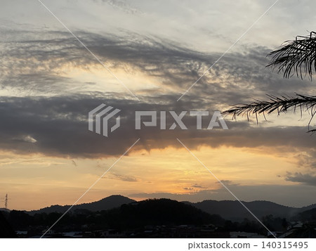 Golden Sunset Sky With Dramatic Cloud Formations Over Jelebu Mountains 140315495