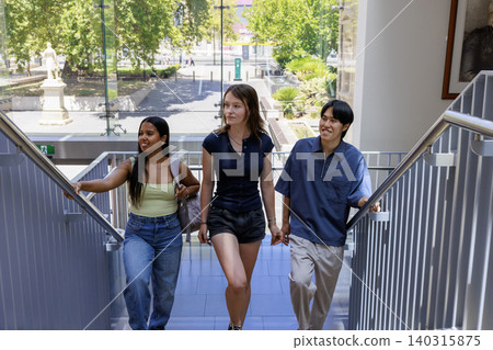 University students climbing the stairs, a scene of campus life. University students climbing the stairs, a scene of campus life. 140315875