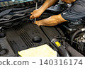 Automotive mechanics working in a car repair shop: Vehicle inspection and maintenance 140316174