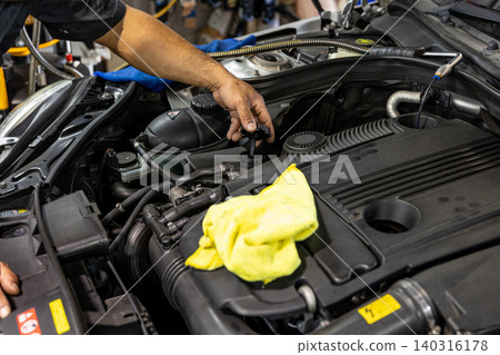 Automotive mechanics working in a car repair shop: Vehicle inspection and maintenance Automotive mechanics working in a car repair shop: Vehicle inspection and maintenance 140316178