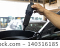 Automotive mechanics working in a car repair shop: Vehicle inspection and maintenance 140316185