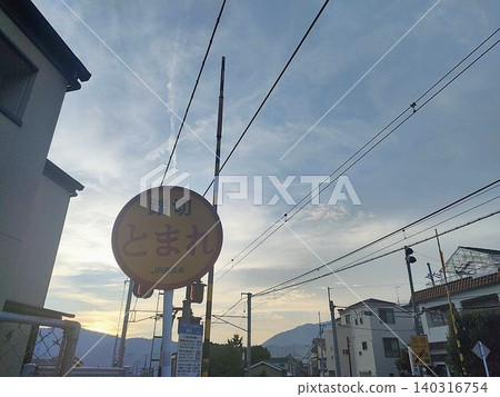 A retro twilight scene and a railway crossing sign. 140316754