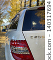 Ginkgo trees and a white Mercedes 140317694