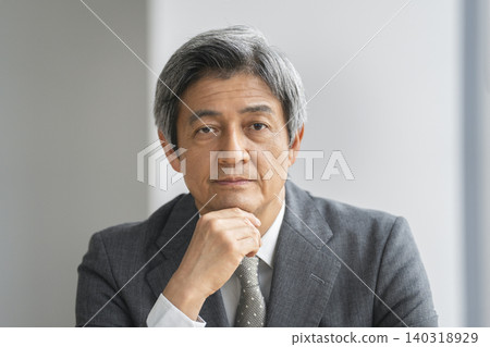Portrait of a businessman in his 60s looking at the camera Portrait of a businessman in his 60s looking at the camera 140318929
