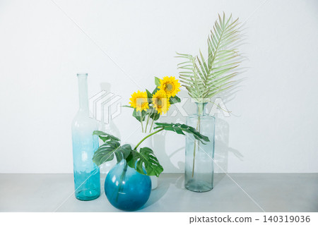 Summer plants in a blue glass bottle Summer plants in a blue glass bottle 140319036