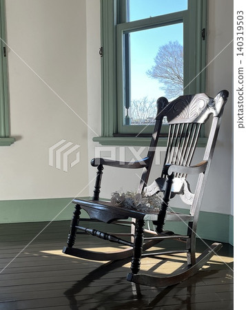 A classic wooden chair in a retro-style interior with white walls. A classic wooden chair in a retro-style interior with white walls. 140319503