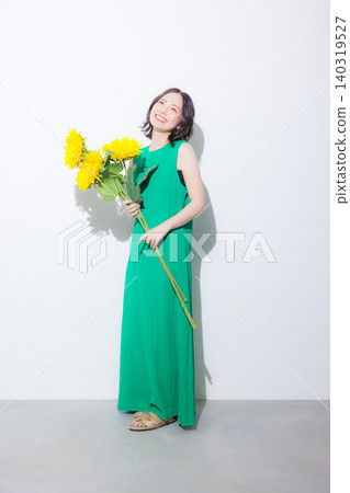 Woman with a bouquet of sunflowers Woman with a bouquet of sunflowers 140319527