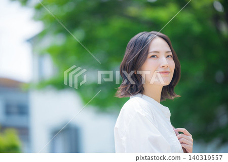 A woman walking in the fresh green A woman walking in the fresh green 140319557