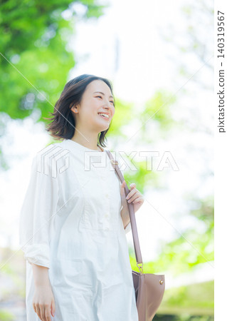 A woman walking in the fresh green 140319567
