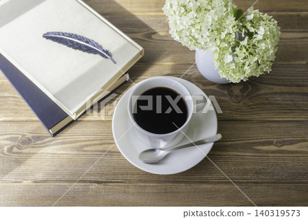 A relaxing time with Annabelle, coffee, and a book. A relaxing time with Annabelle, coffee, and a book. 140319573