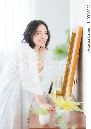 Young woman looking at a mirror Young woman looking at a mirror 140319662