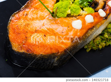 Baked salmon steak with broccoli Baked salmon steak with broccoli 140321718