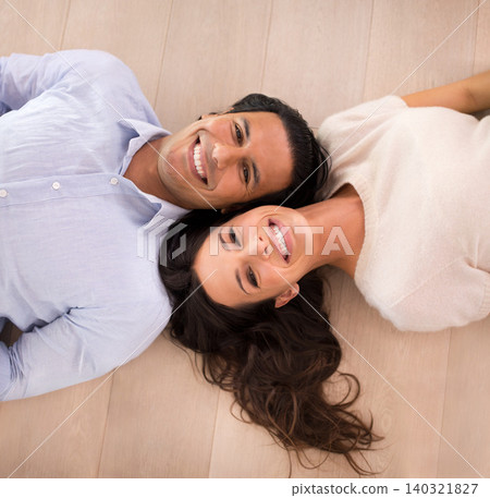 Portrait, happy and top view of couple on floor, relax and bonding together in home. Above, man and face of woman with a smile for connection, love and commitment for healthy relationship in house Portrait, happy and top view of couple on floor, relax and bonding together in home. Above, man and face of woman with a smile for connection, love and commitment for healthy relationship in house 140321827