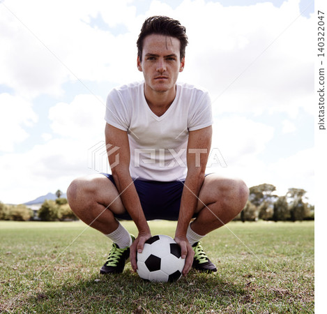 Man, soccer ball and portrait on ground for sports with pride, confidence and ready for challenge on field. Person, athlete and football player on grass for exercise, workout and training for game Man, soccer ball and portrait on ground for sports with pride, confidence and ready for challenge on field. Person, athlete and football player on grass for exercise, workout and training for game 140322047