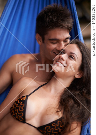 Couple, hammock and vacation in swimwear with smile for love, affection and travel honeymoon. Together, summer and happiness on holiday with trip in relationship, care and outdoor with bonding. Couple, hammock and vacation in swimwear with smile for love, affection and travel honeymoon. Together, summer and happiness on holiday with trip in relationship, care and outdoor with bonding. 140322263