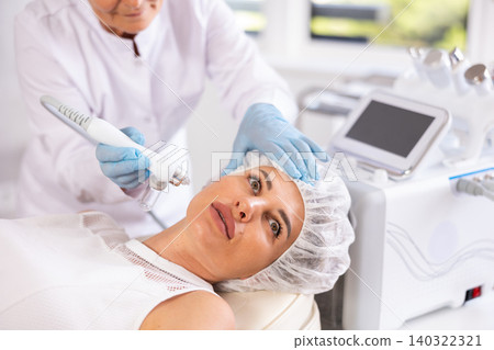RF lifting and deep hydration for facial skin on young woman in clinic RF lifting and deep hydration for facial skin on young woman in clinic 140322321