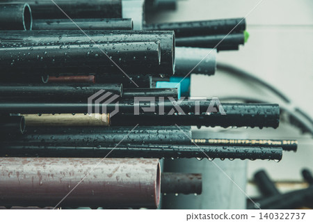A group of black pipes soaked in rain A group of black pipes soaked in rain 140322737