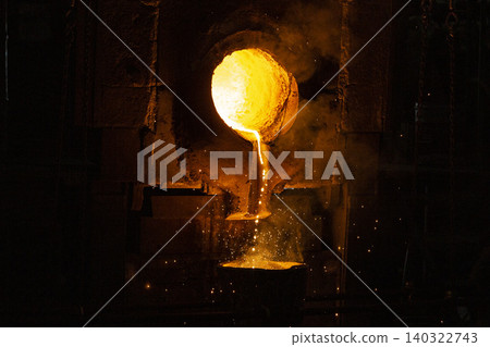 Pouring molten metal from the furnace into the tundish Pouring molten metal from the furnace into the tundish 140322743