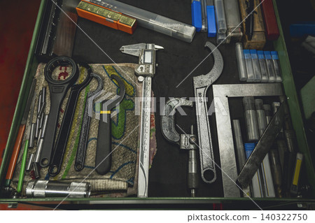 Precision measuring tools lined up in a tool drawer Precision measuring tools lined up in a tool drawer 140322750