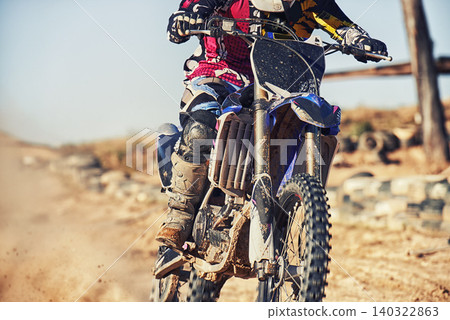 Person, motorcyclist and track with dirt bike for race, extreme sports or outdoor competition. Closeup or legs of expert rider on motorbike, scrambler or sand course for off road rally challenge Person, motorcyclist and track with dirt bike for race, extreme sports or outdoor competition. Closeup or legs of expert rider on motorbike, scrambler or sand course for off road rally challenge 140322863