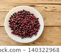 falsa berries on white plate placed over rustic wooden table 140322968