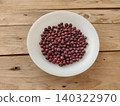 Fresh phalsa berries on white plate with wooden table 140322970