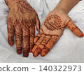 Karachi Pakistan Senior woman showing decorative henna patterns on hands during cultural celebration 140322973