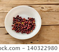 Raw and ripe phalsa berries arranged neatly on wooden table 140322980