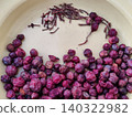Spoiled phalsa berries with stems and seeds on old plate 140322982
