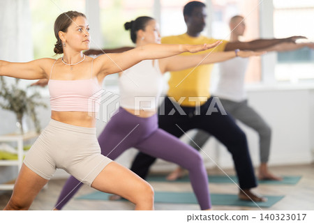 Young woman doing pilates in group in studio Young woman doing pilates in group in studio 140323017
