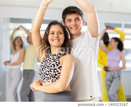 Young man and woman practicing waltz dance in pair in training hall Young man and woman practicing waltz dance in pair in training hall 140323167