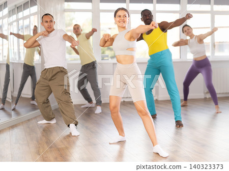 Young woman practicing Capoeira dance in training hall Young woman practicing Capoeira dance in training hall 140323373