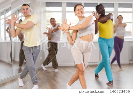 European girl with team of like-minded multinational people learn to elements of electro dance European girl with team of like-minded multinational people learn to elements of electro dance 140323409