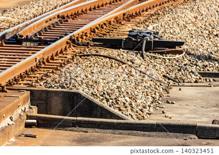 Close-up of railway switches and electric point motors. Close-up of railway switches and electric point motors. 140323451