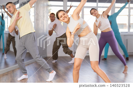 European girl with team of like-minded multinational people learn to elements of electro dance European girl with team of like-minded multinational people learn to elements of electro dance 140323528