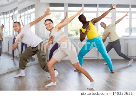 European girl with team of like-minded multinational people learn to elements of electro dance European girl with team of like-minded multinational people learn to elements of electro dance 140323631