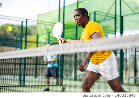African american man playing padel tennis African american man playing padel tennis 140323648