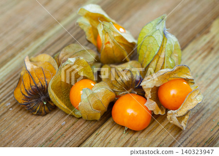 Orange physalis fruit on wooden desk Orange physalis fruit on wooden desk 140323947