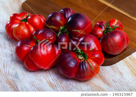 Tasty appetizing blue tomatoes on wooden surface Tasty appetizing blue tomatoes on wooden surface 140323967