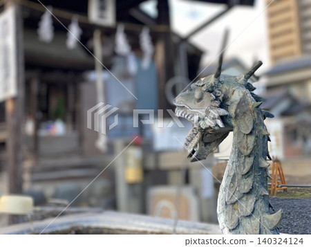 A dragon statue at the purification fountain of a shrine A dragon statue at the purification fountain of a shrine 140324124